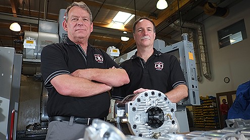 From left, GoTek Energy’s Steve Herbruck and Scott Farrenkopf show off a test prototype of the company’s new rotary engine. Designed to address problems with existing rotary engines, the unit can use nearly any combustible fuel. (Stephen Nellis photo)