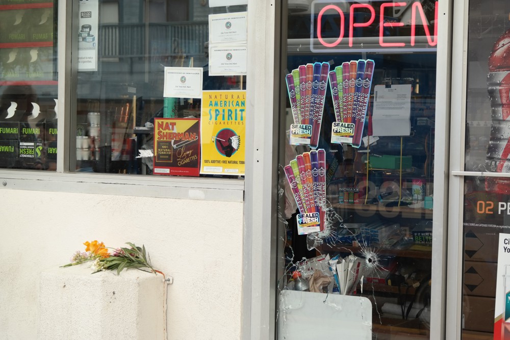 Bullet holes in the window of IV Deli Mart, where one of Elliot Rodger's victims was shot and killed shortly before 10 p.m. on Friday, May 23. The store remained closed Saturday as law enforcement gathered information on the series of events. (Erika Martin / Business Times photo)