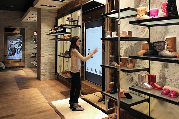 A shopper navigates Deckers Brands’ so-called omni-channel retail concept at the company’s newest Ugg Australia store, in Washington, D.C. (Courtesy image)