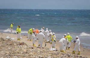 Workers donned protective gear clean up the oil spill at Refugio campgrounds.