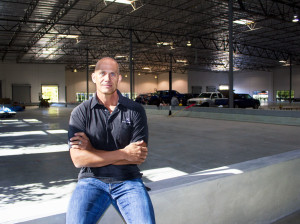 Sports Academy CEO Chad Faulkner sits on the edge of what will be the facility's beach volleyball courts. (Alex Kacik)