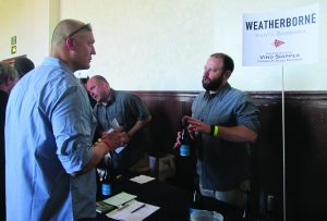 Winemaker Cris Carter of Weatherborne speaks with a visitor at the Garagiste Festival in Solvang on Feb. 14.